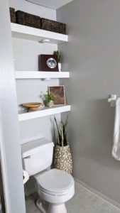 Floating shelves above the toilet