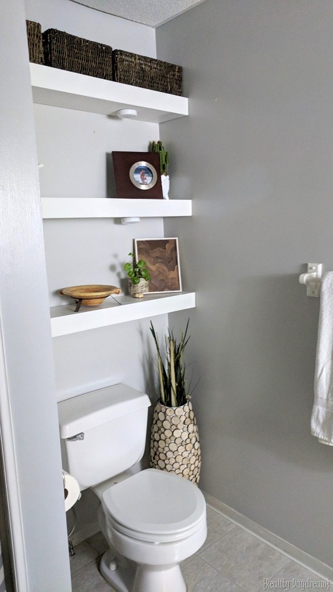 Floating shelves above the toilet