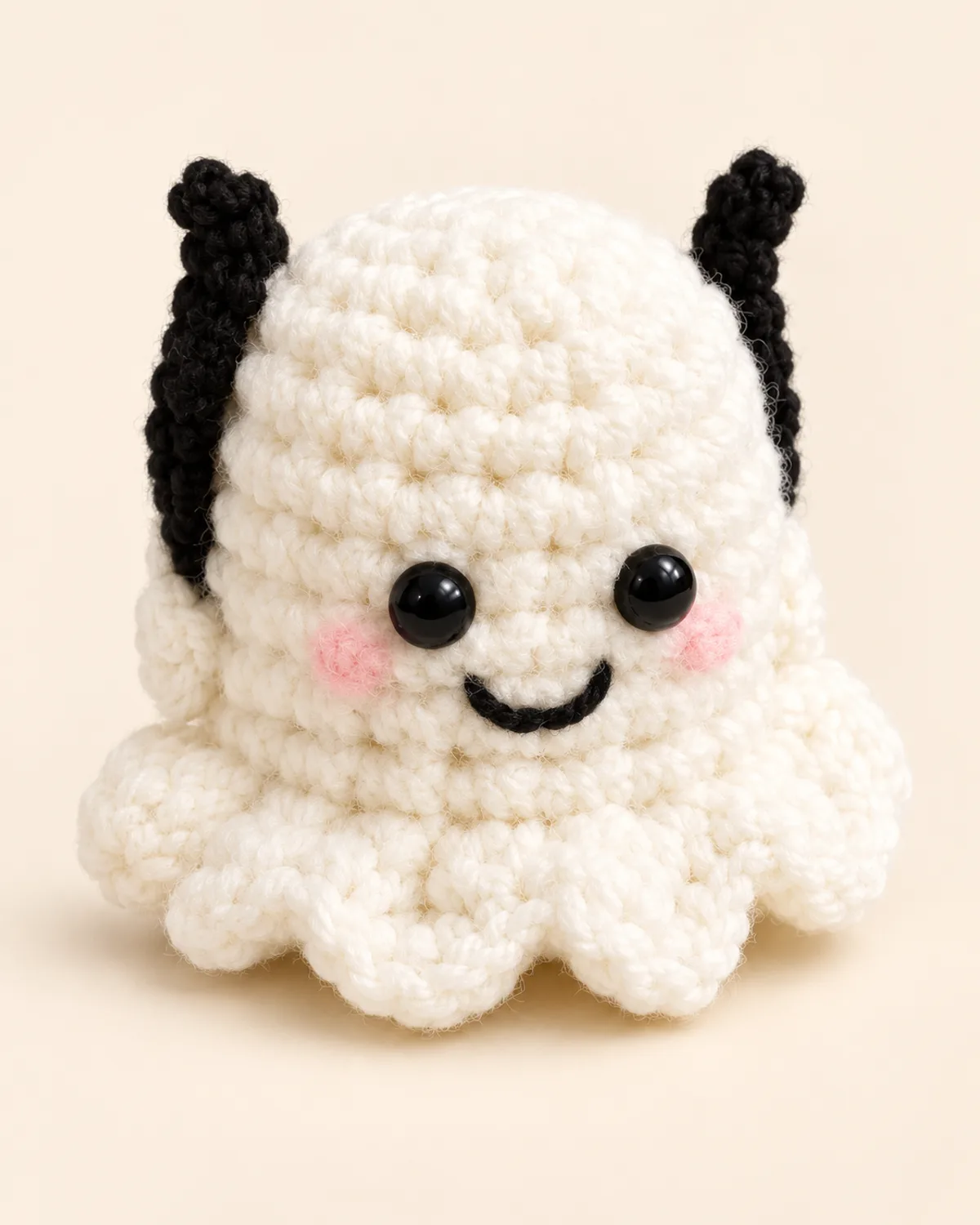 Halloween Ghost Amigurumi, finished product on a warm off-white background
