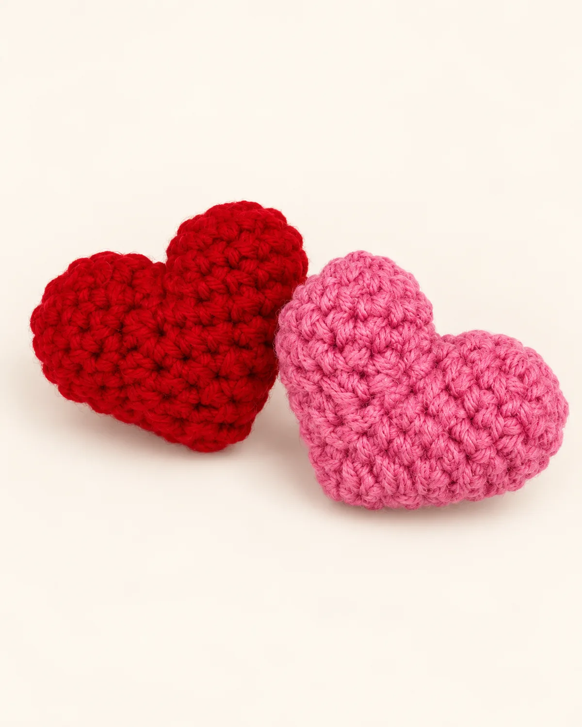 Mini Heart Amigurumi, finished product on a warm off-white background