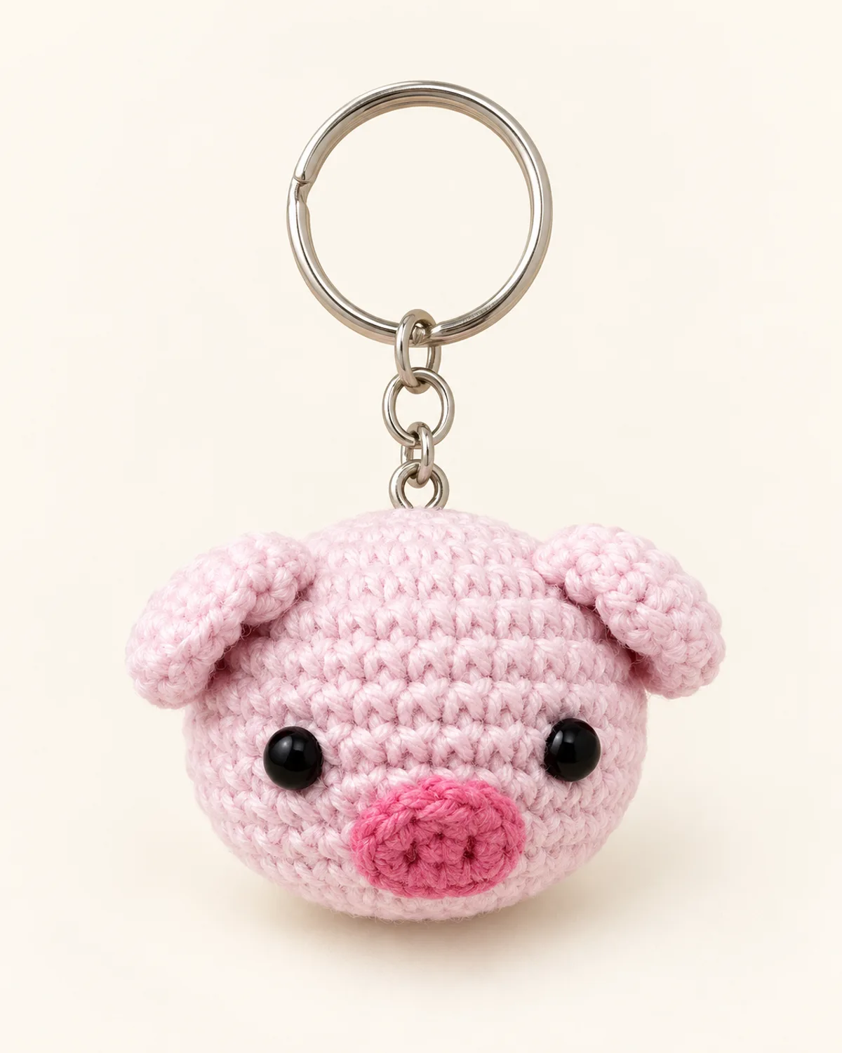 Piglet Keychain, finished product on a warm off-white background