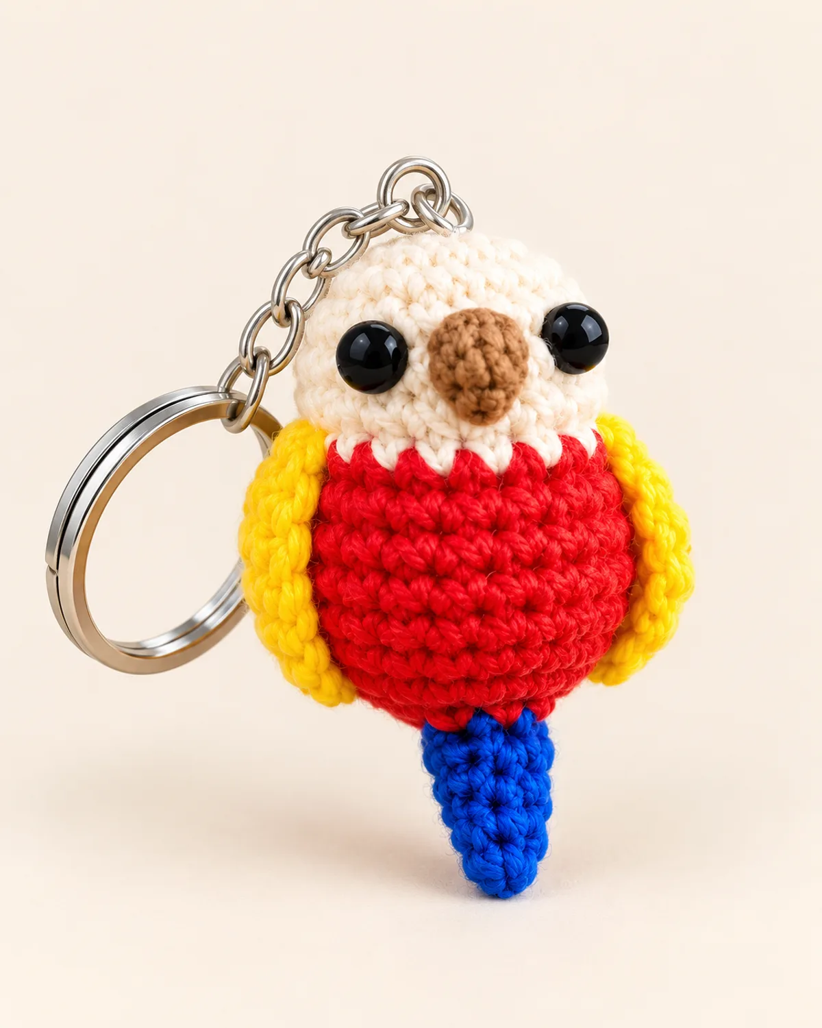 Parrot Keychain, finished product on a warm off-white background