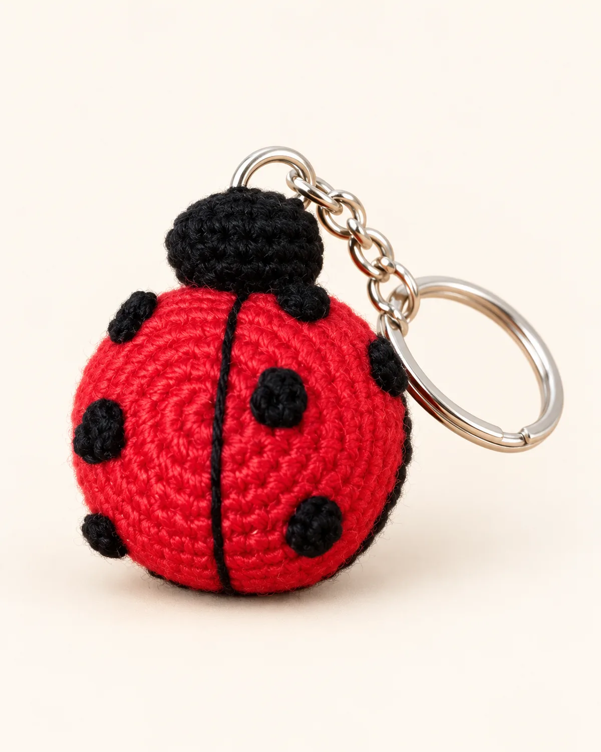 Ladybird Keychain, finished product on a warm off-white background