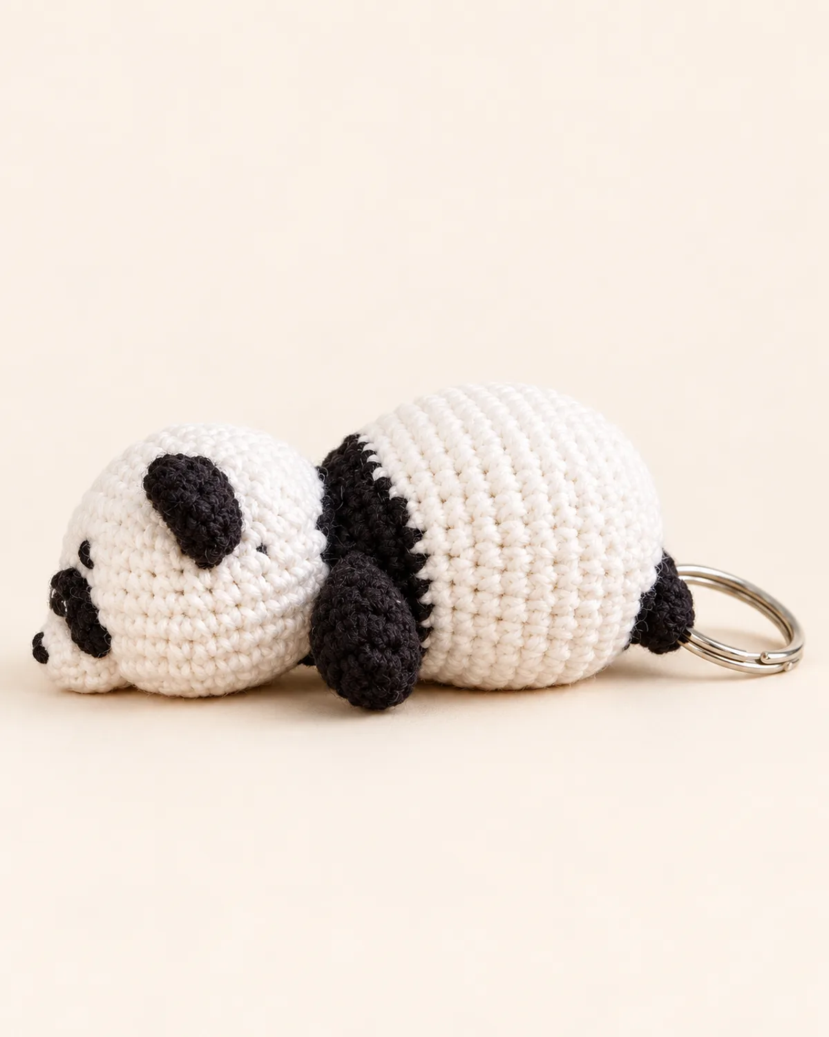 Panda Keychain, finished product on a warm off-white background