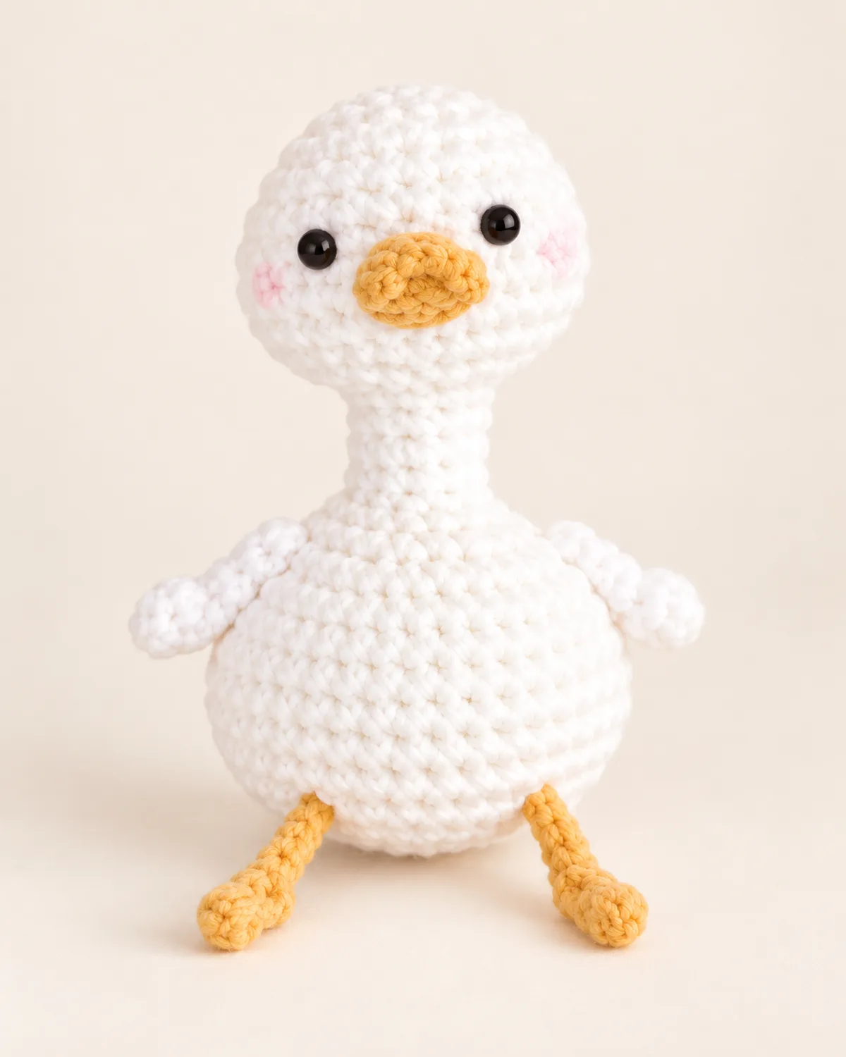 Duck Amigurumi, finished product on a warm off-white background
