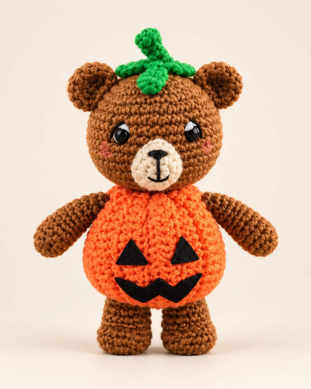 Bear in Pumpkin Costume, finished product on a warm off-white background